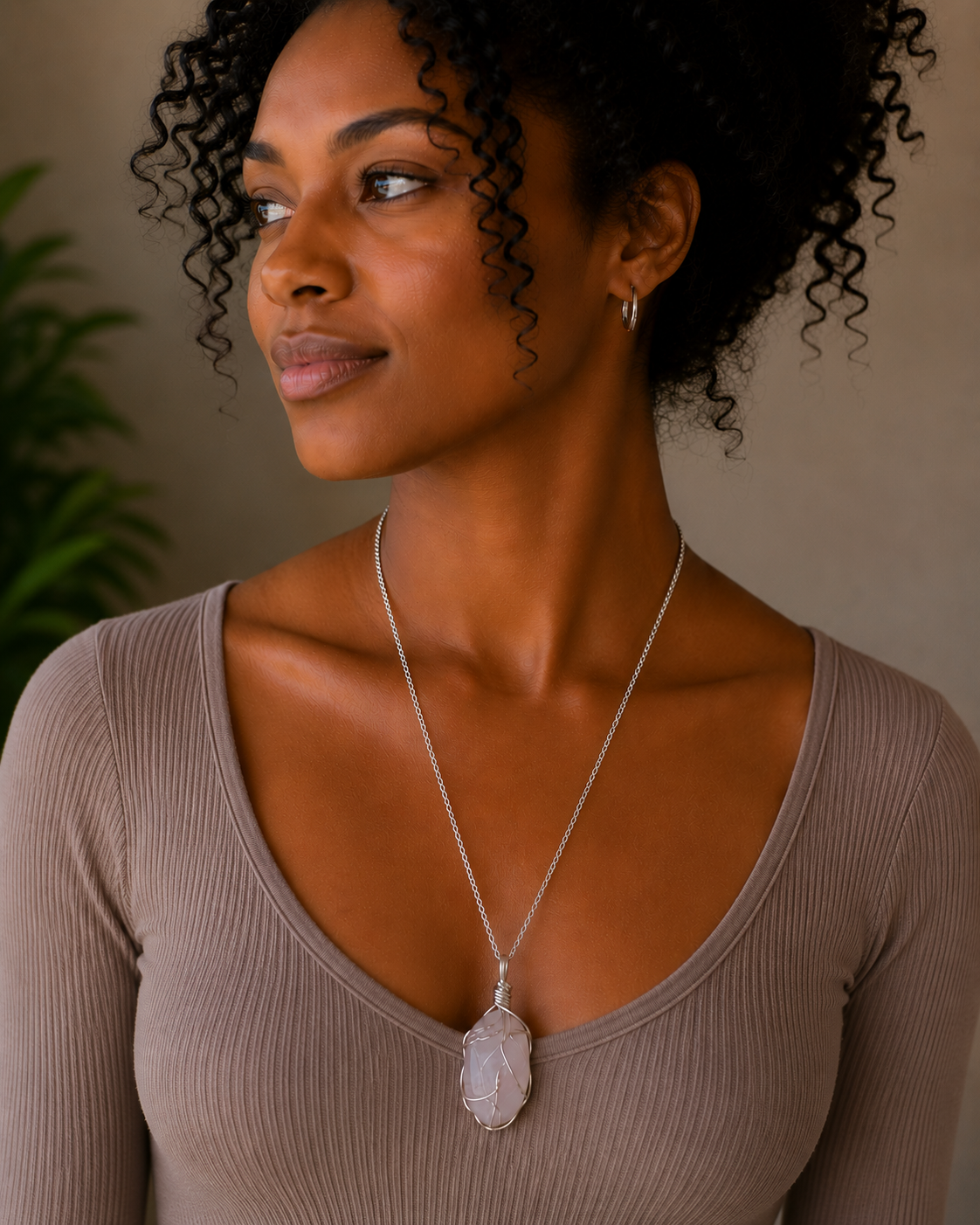 Woman wearing a necklace with a neutral background