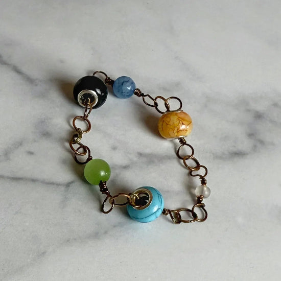 Bracelet with colorful beads on a marble surface