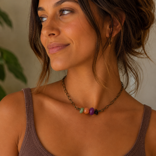 Woman wearing a necklace with colorful beads against a neutral background