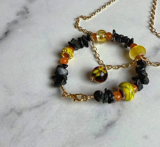Necklace with colorful beads on a marble surface