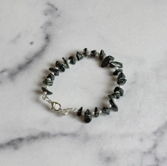 Bracelet with black and white beads on a marble surface