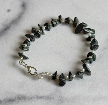 Bracelet with black and white beads on a marble surface
