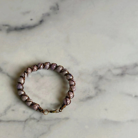 lepidolite beaded bracelet on a marble surface