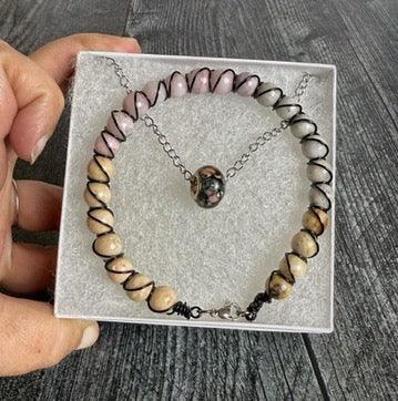 Necklace with heart-shaped pendant on a gray textured surface